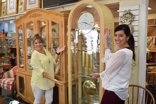 Ladies smiling in front of clock